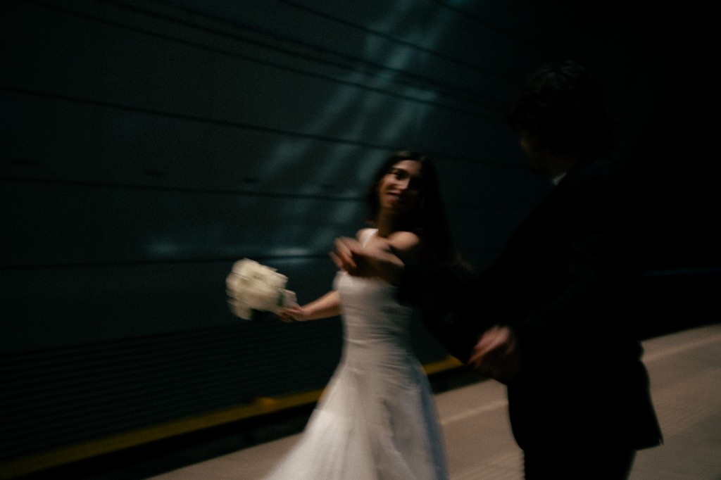 Bride and groom in motion, blurred, in a dark underground passage